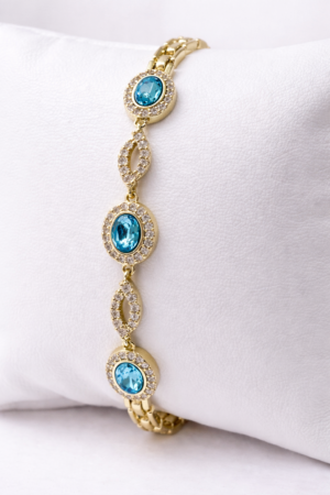 14k gold layered bracelet with blue cubic zirconia stones and halo design