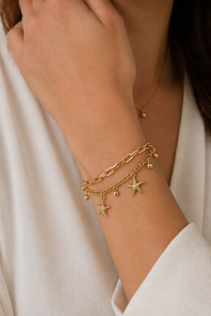 14K gold layered star charm bracelet worn on wrist – bracelet and anklet jewelry